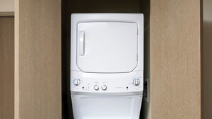 A compact, built-in washer and dryer unit with a control panel and ventilation slits on the sides.