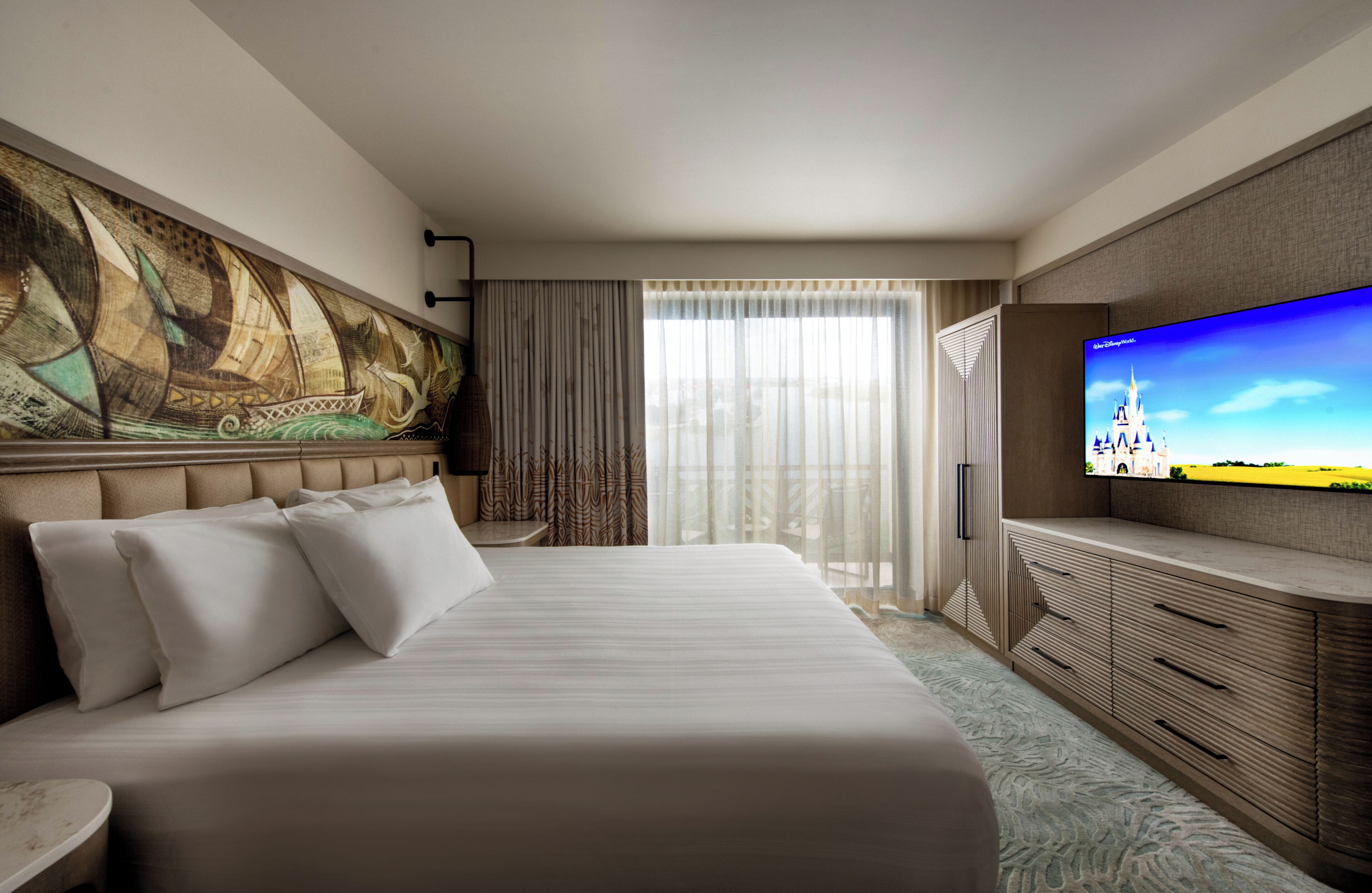 A hotel room with a large bed, a flat-screen TV, a painting on the wall, and a view of the outdoors.