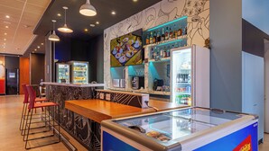 A modern bar area with a counter, stools, and a large ice cream machine. - Transamerica Fit Aracruz (Aracruz)