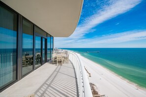 A balcony with a view of a beach and ocean. - Phoenix Gulf Shores Ii 2005 4 Bedroom Condo (Gulf Shores)