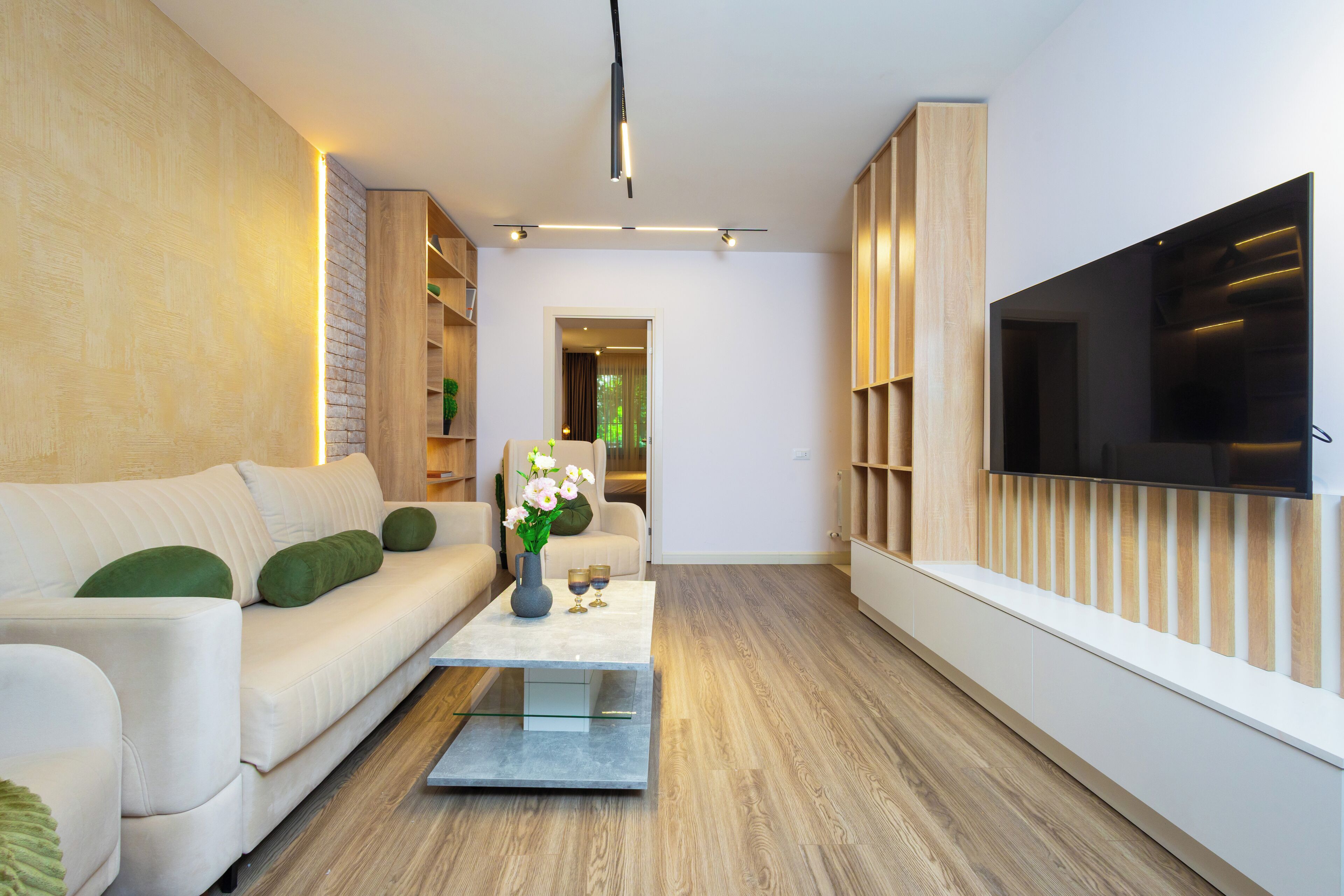 A modern living room with a sofa, coffee table, and TV.