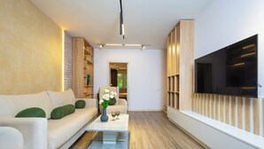 A modern living room with a sofa, coffee table, and TV.
