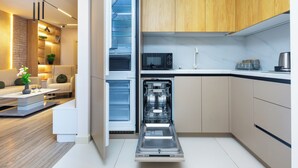 A modern kitchen with a dishwasher, microwave, and wooden cabinets.
