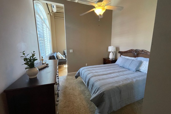 Bright and comfortable bedroom with high ceilings and modern charm — unwind at The Gateway Village in Murfreesboro.