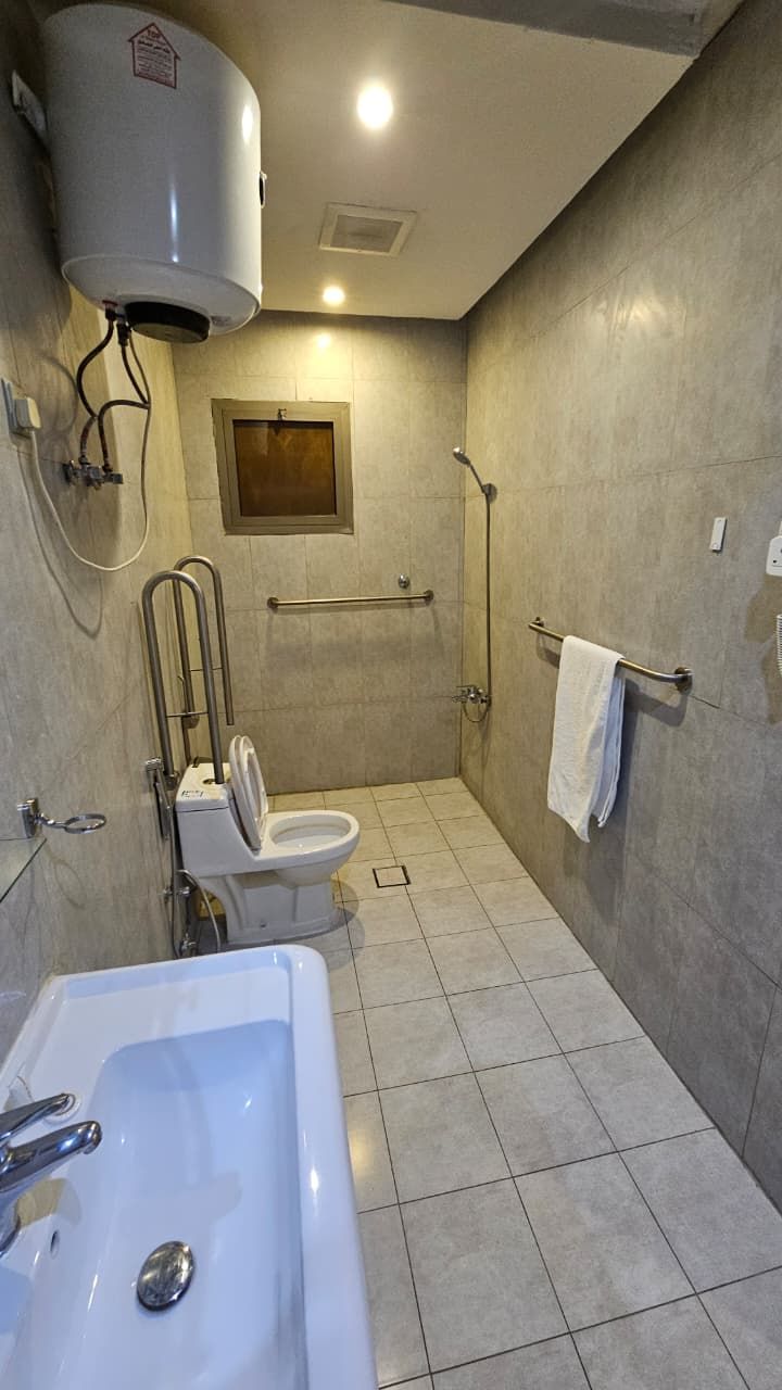 A bathroom with a toilet, a bathtub, and a shower.