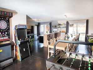 A modern kitchen with a dartboard, a foosball table, and a dining area with a view. - Single-storey Holiday Home in Heers (Heers)