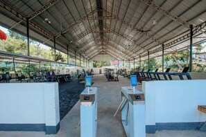 An indoor facility with a high ceiling and metal beams, featuring multiple counters and seating areas. - Fu Er Man Hotel (Luang Prabang)