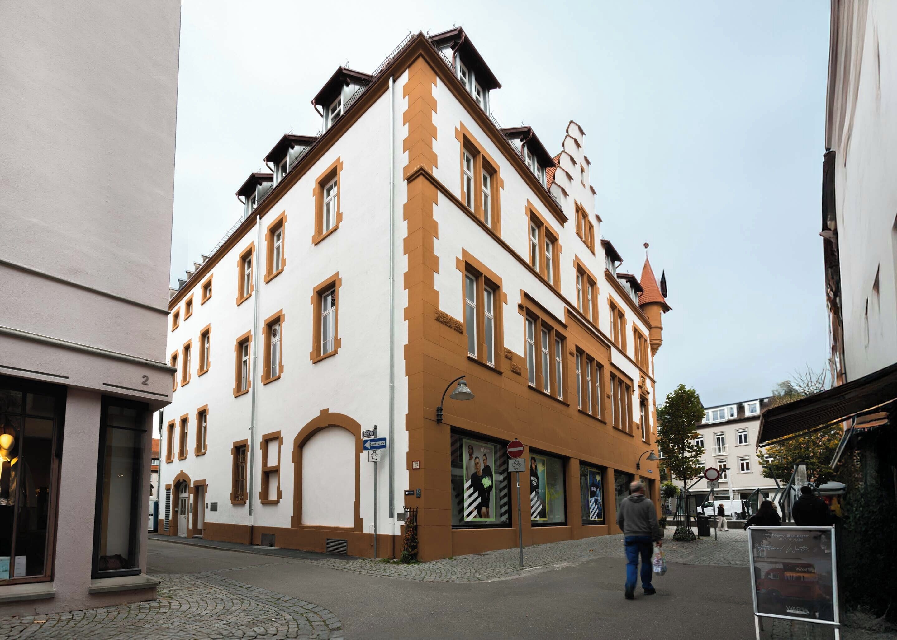 A historic building with multiple windows and a corner entrance.