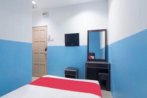 A room with a bed, a television, a mirror, and a door. - Mines Cempaka Budget Hotel (Nilai)
