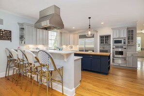Fridge, dishwasher, coffee/tea maker, cookware/dishes/utensils