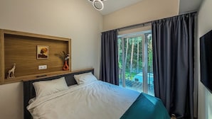 A bedroom with a bed, a wooden headboard, a wall-mounted shelf with decorative items, a ceiling light fixture, and a view of a balcony with curtains. - ForRest Cozy Apartments Minsk (Minsk)