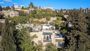 A residential area with multiple buildings, some with balconies and terraces. - Timeless Charm, Stunning Views & Serene Comfort (Jerusalem)