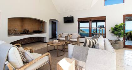 Spectacular ocean view with vibrant fynbos in the foreground.