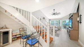 A modern interior with a staircase, dining area, and a kitchen. - Heated Pool, FREE WIFI Luxury Bayside Condo Across from Siesta Key Beach |  Beautiful 3BR/2BA Gulf & Bay Club Bayside Condo (Sarasota)