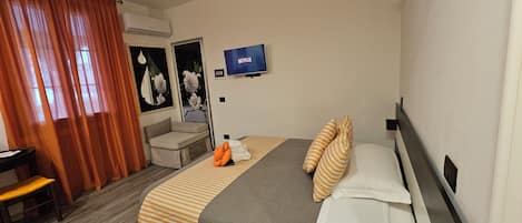 Triple Room, Multiple Beds, Patio, Courtyard View | Desk, laptop workspace, blackout drapes, soundproofing