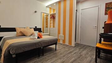 A bedroom with a bed, bedside table, and a wardrobe.