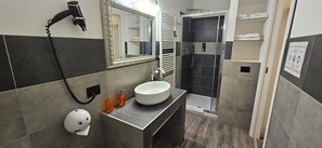 Quadruple Room, Multiple Beds, Patio, Courtyard View | Bathroom | Shower, hair dryer, towels, soap - Wagon-lit (Bologna)