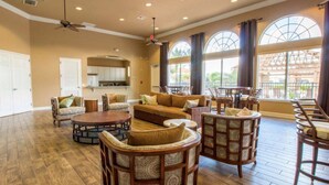 A spacious living area with a large sofa, multiple chairs, a coffee table, and a kitchen in the background. - Bella Vida Cozy Home | 15 min to Disney | Resort Style (Kissimmee)