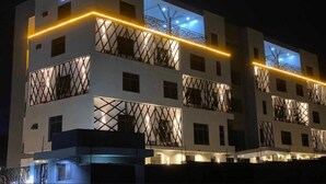 A modern building with a sign reading "PLOT 541". It features multiple balconies with metal railings and a flat roof design. - Sapphire Suite (Abuja)