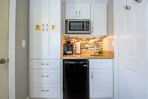 Fridge, microwave, coffee/tea maker, cookware/dishes/utensils