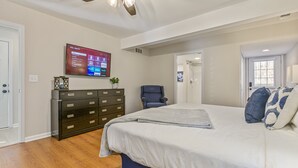 A bedroom with a bed, a dresser, a TV mounted on the wall, and a ceiling fan. - 27 West Ridge Drive SE, Cartersville (Cartersville)