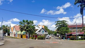 A street view with a building labeled "Hotel & Resort" and a palm tree.