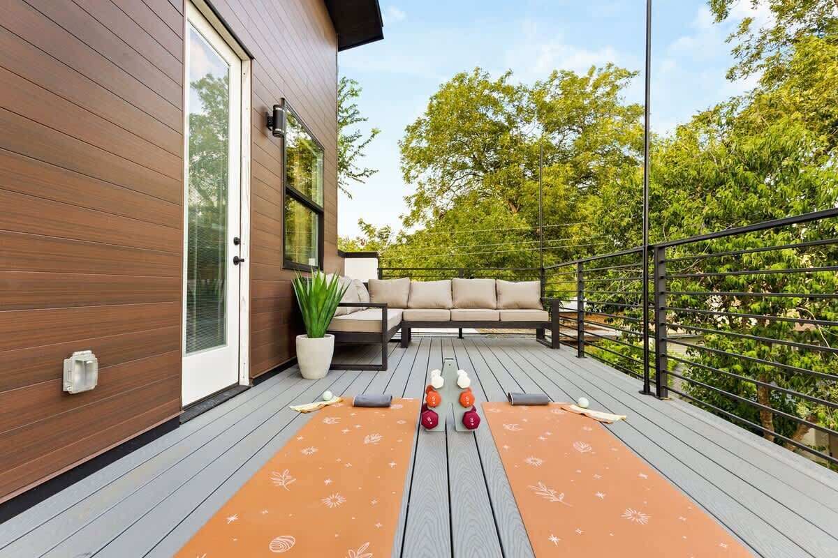 A deck with a sofa, a potted plant, and a table with a ball game setup.