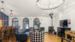 A cozy living room with a fireplace, comfortable seating, and a television.