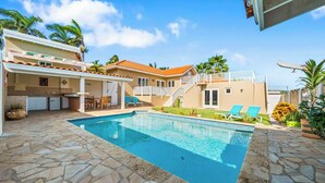 A two-story house with a swimming pool, outdoor seating, and a staircase leading to a balcony. - Private Pool! Rooftop with Ocean View! (Savaneta)