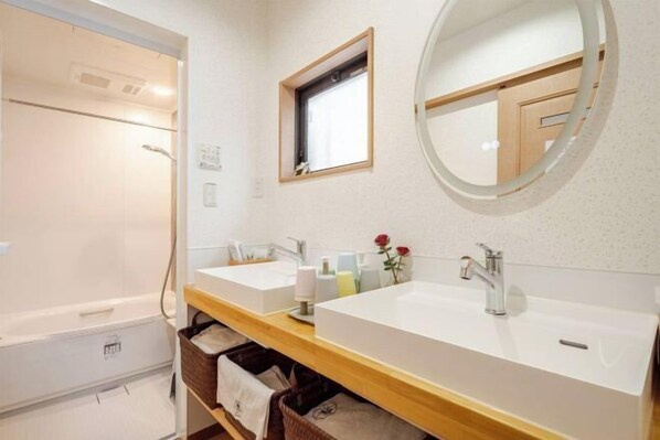 A bathroom with two sinks, a shower, a window, and a mirror. - Lighthotel-takasago (Tokyo)
