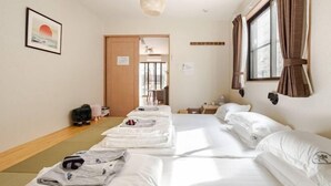 A hotel room with a bed, a desk, a chair, a window with curtains, and a picture on the wall. - Lighthotel-takasago (Tokyo)