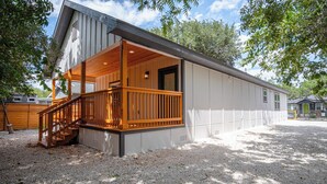 A single-story building with a wooden deck and a covered porch.