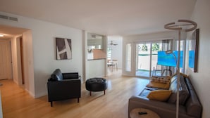 A modern living room with a black sofa, ottoman, and a round coffee table. - Guard Gated Golf Course 1mi to Vegas Strip Best Kept Secret Quiet Secure 9 (Las Vegas)
