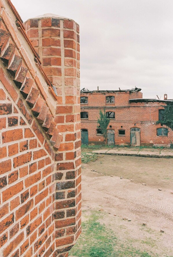 A brick building with a staircase leading up to a door.