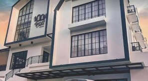 A multi-story building with large windows and balconies. - Bianco Costel (Central Bogor)