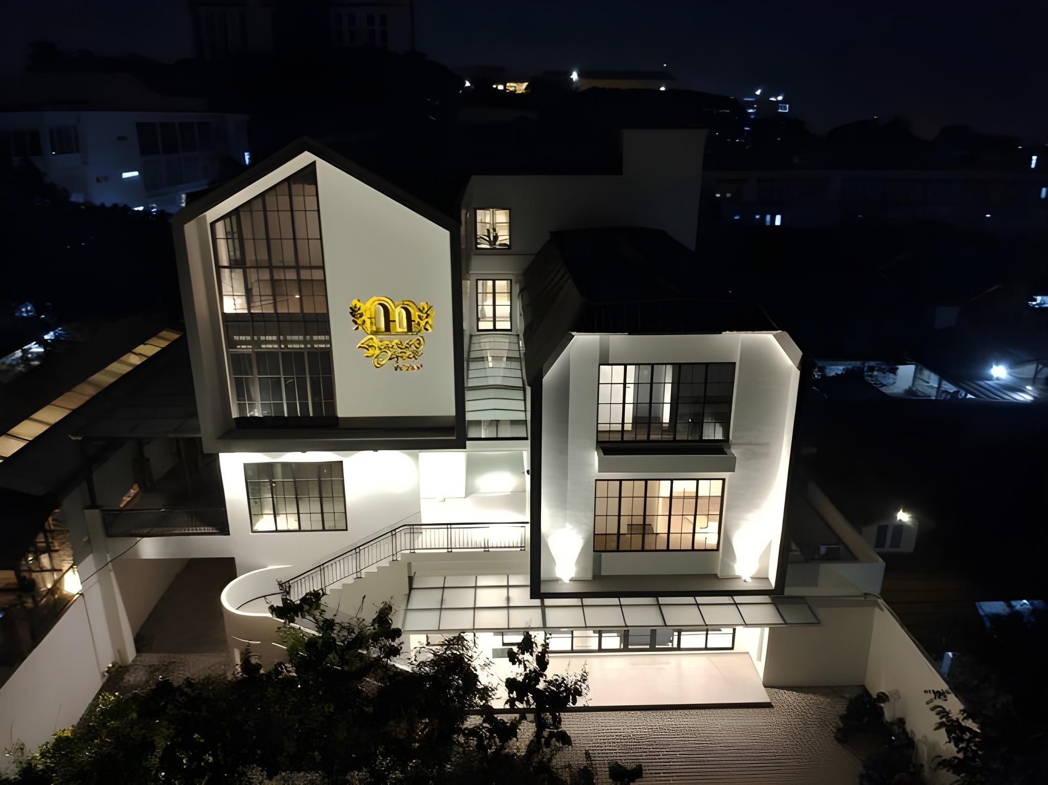 A modern two-story building with a prominent logo on the facade.