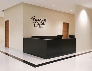 A reception desk with a sign that reads 'Bianco Castel Bogor.' - Bianco Costel (Central Bogor)
