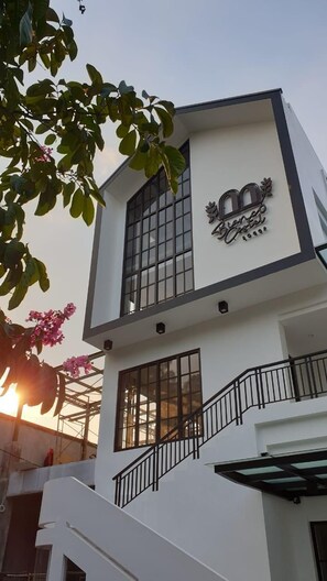 A modern building with a balcony and a staircase. - Bianco Costel (Central Bogor)