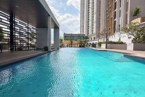 A swimming pool with a modern architectural design, surrounded by high-rise buildings. - Sky Tree by RR JBcity (Johor Bahru)