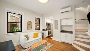 A modern apartment with a living room, kitchenette, and a staircase. - Hidden Gem 2BD w/ Patio, Near Findlay Market, UC (Cincinnati)
