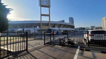 A stadium with a large seating area and a tall light structure.