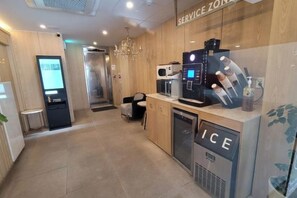 A hotel lobby with a service zone, a self-service kiosk, a coffee machine, and a refrigerator. - Hotel Label Seongnam (Seongnam)