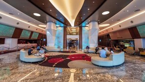 A spacious lobby with a central seating area, high ceilings, and modern lighting.