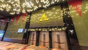 The Sunway Pyramid Convention Center entrance with a distinctive logo, a modern design, and a check-in desk.