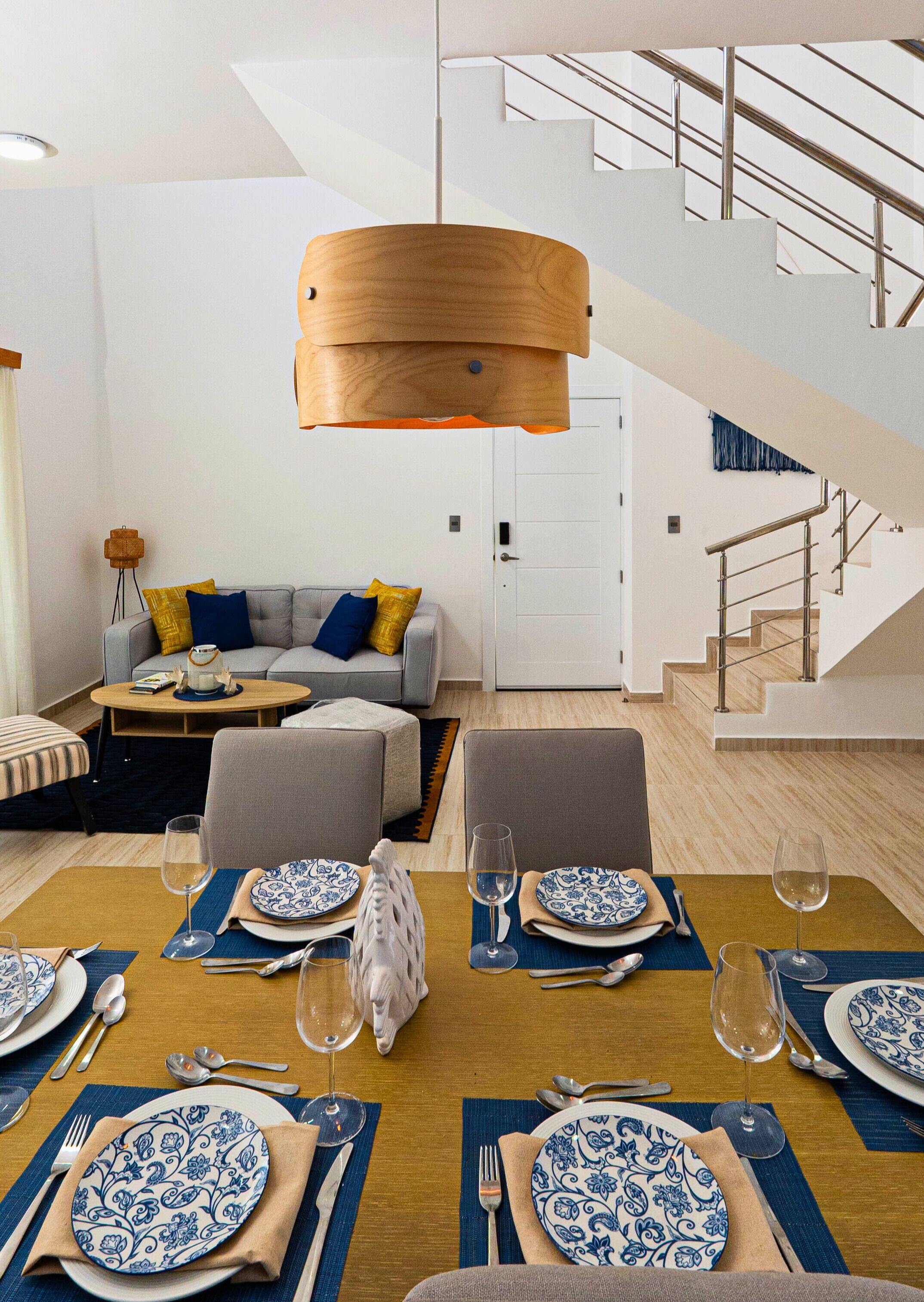 A modern living room with a dining area set for six.