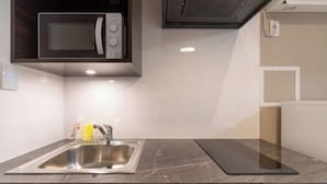 A kitchen with a stainless steel sink, a microwave, and a built-in oven. - LaVie Hatsudai (Tokyo)