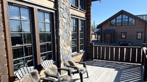 A wooden deck with Adirondack chairs and a stone pillar. - Mountain cabin for the whole family - near skiing, golf and hiking | SE19053 (Idre)