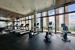 A gym with treadmills, elliptical machines, and weight stations. - Queen Suites Tropicana The Residence by KLCC (Kuala Lumpur)