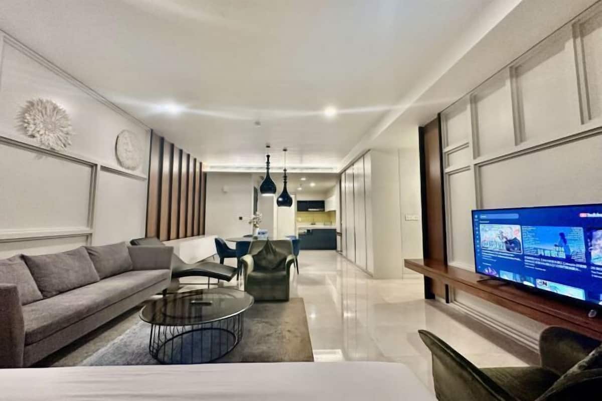 A modern living room with a sofa, coffee table, and TV.