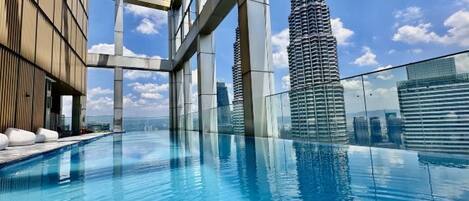A swimming pool with a view of a tall building.